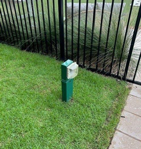 a green power pedestal in Ritz Carlton lawn with an electrical cover